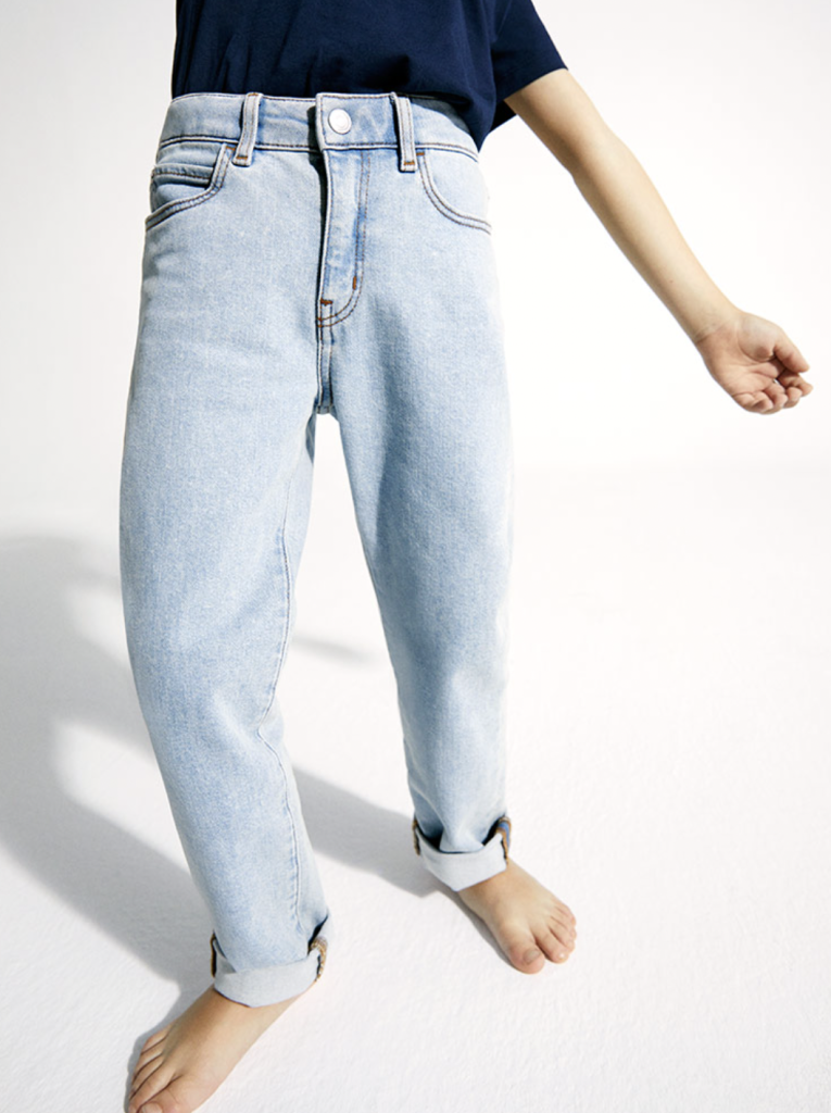 photo of lower body in ami five pocket jeans in relaxed fit, made from medium blue washed GOTS certified organic Italian cotton