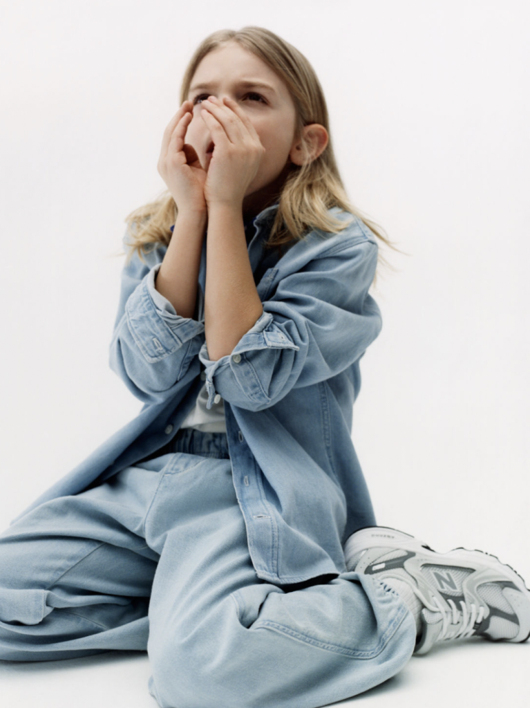 longhaired kid in double denim set in light blue wash